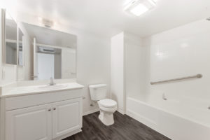 wood flooring bathroom with bathtub and shower