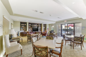 community tv room with lounge area and tables