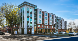 exterior of building, windows, and businesses along street