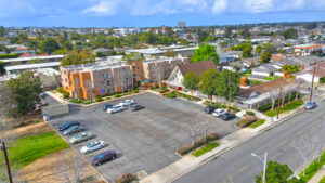 Aerial Exterior, View st. johns manor, parking lot, and surrounding areas. photo taken on a sunny day.