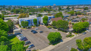 Aerial Exterior of St. Johns Manor and parking lot. 3 stories, meticulous lush landscaping around the complex.