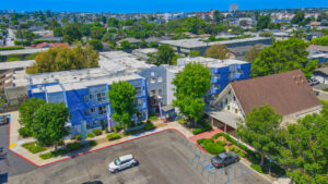 Aerial Exterior, View st. johns manor, parking lot, and surrounding areas. photo taken on a sunny day.