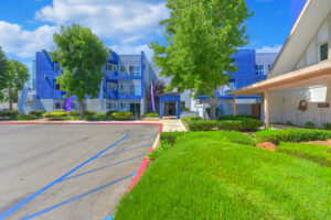 Exterior St Johns Manor, Parking lot, Avanath flags in front of the building.
